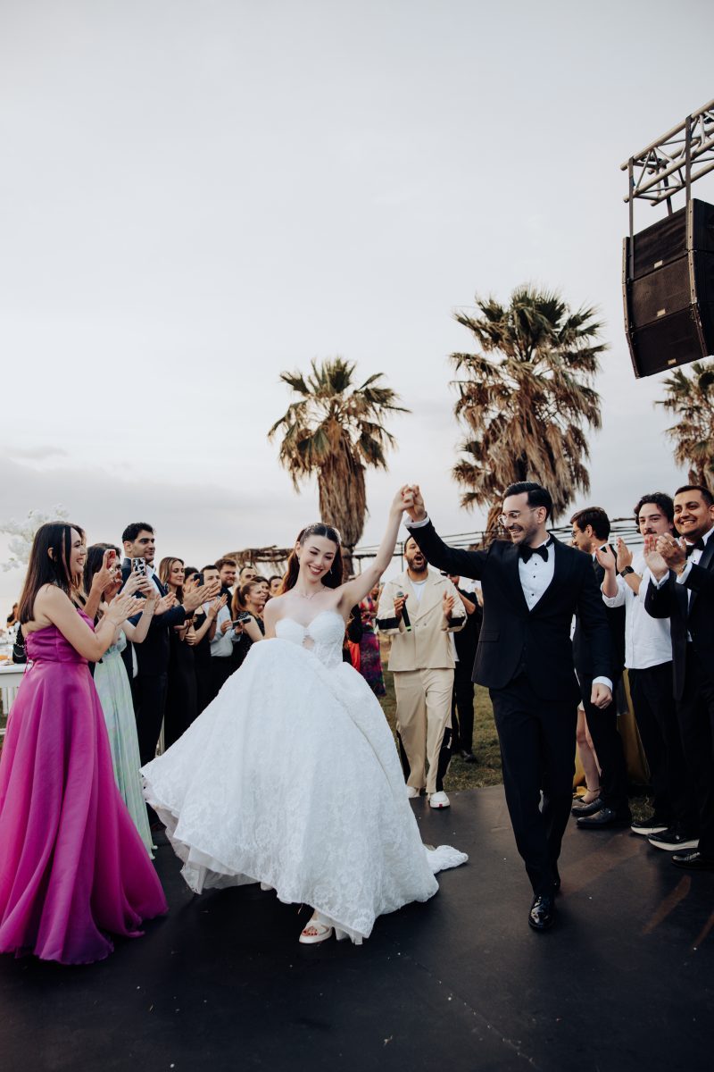 Bride and groom dancing as they walk among the wedding guests